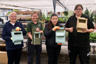 Members of Flourish holding the bird boxes they've built from scratch. Photo by Aimee Buck.
